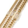Gold stainless steel Cuban link necklace with diamond accents shown in close-up