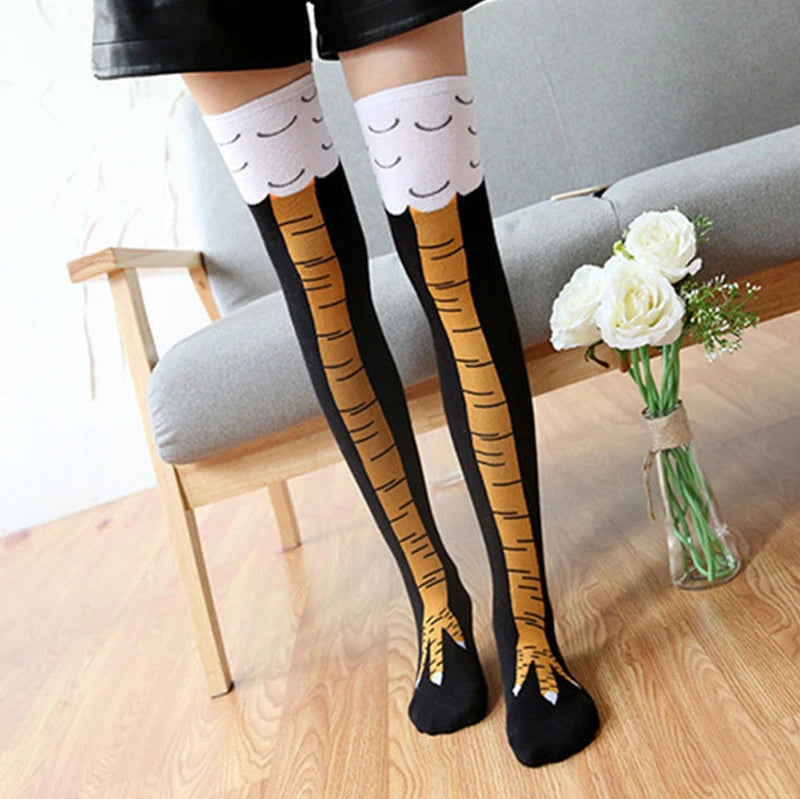 Pair of black socks with gold chicken print and white ruffled cuffs