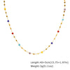 A long, delicate necklace featuring irregular colored stones and gold-toned beads.