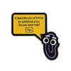 A yellow enamel lapel pin shaped like a speech bubble with text asking if someone needs help and a 'Yes' button, attached to 