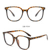 A pair of brown tortoiseshell framed eyeglasses shown from the front and side angles.