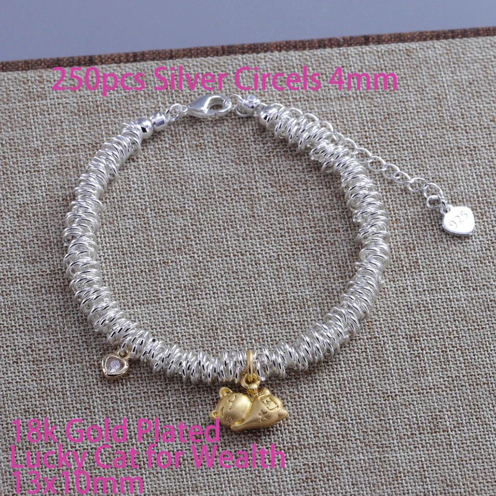 Silver heart charm bracelet with a silver chain and a gold-plated lucky cat pendant