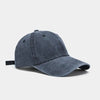 A dark gray washed cotton snapback cap shown from the side.