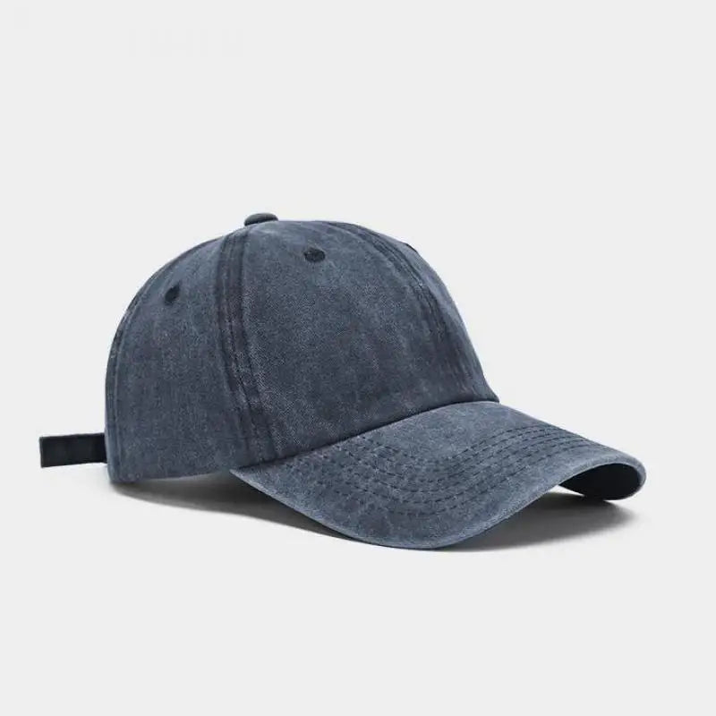 A dark gray washed cotton snapback cap shown from the side.