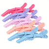 A set of pink and purple professional multifunctional hair sectioning clips.