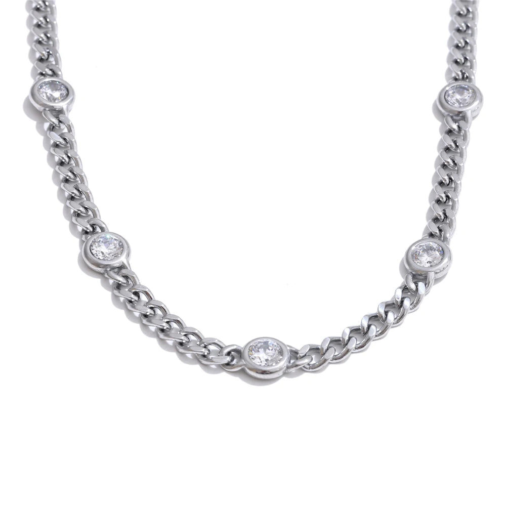 A silver stainless steel charm necklace featuring small cubic zirconia stones.