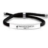 Black cord bracelet with a silver bar and a white plaque engraved with the text Seek and you shall find Mat 7:7
