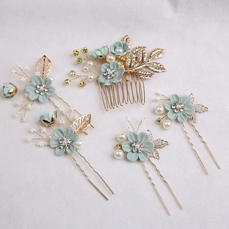 A set of five floral pearl bridal hair accessories featuring light blue flowers and gold accents.