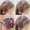 A close-up of a woman's hair styled with black and colorful rhinestone elastic hair hoops