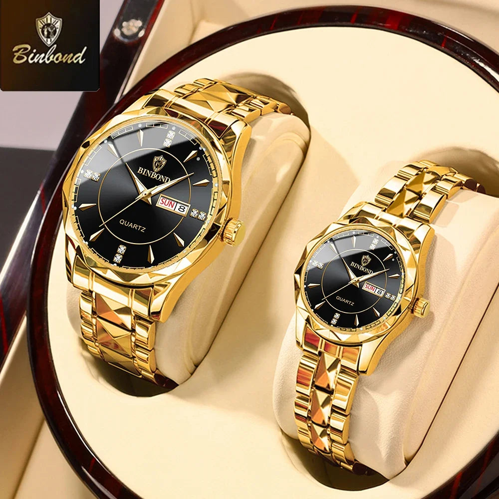 A pair of gold-toned quartz watches displayed on a wooden stand.