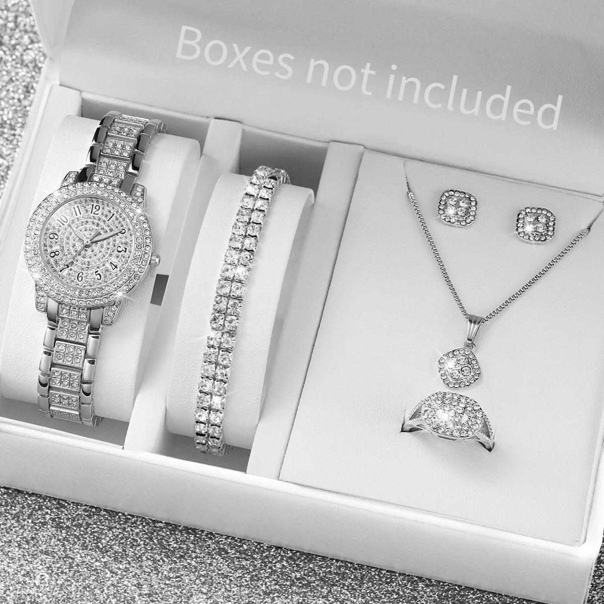 A white box contains a set of gold steel quartz watches, bracelets, and necklaces.