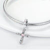 A sterling silver devil's eye charm bracelet with a cross pendant displayed on a white background.