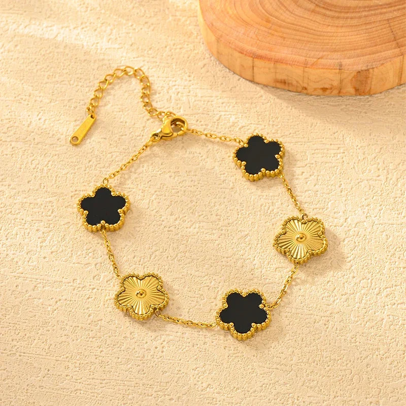Gold plated stainless steel double-sided petal bracelet with black and gold floral accents