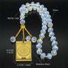 A necklace featuring blue glass beads and a gold-colored pendant on a gold chain.
