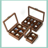 A wooden multi-slot display box for watches and jewelry, featuring compartments for various items.