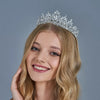A blonde woman wearing an elegant crystal rhinestone tiara and headband set.
