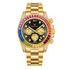 A gold quartz watch with a black dial, pink and blue accents, and diamond-set bezel and crown.