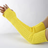 A hand wearing a yellow knitted fingerless glove, showing the texture and fit of the garment.
