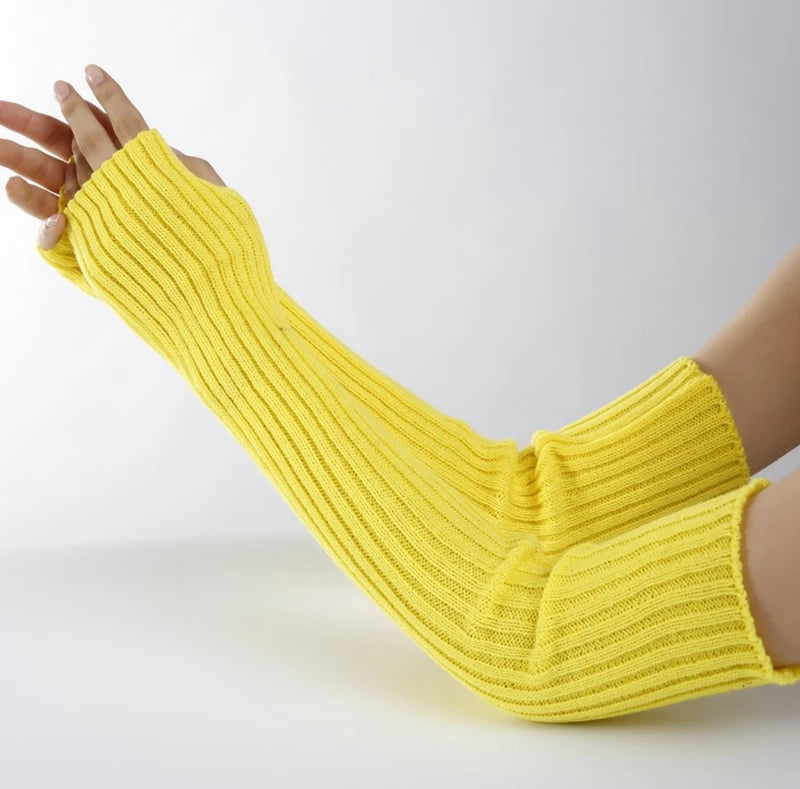 A hand wearing a yellow knitted fingerless glove, showing the texture and fit of the garment.