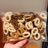 A pile of cute elastic hair bands in various shades of brown and beige is shown in a clear plastic bag.