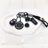 A set of five black fitness keychains and weightlifting accessories including a fitness weight and a sport bottle.