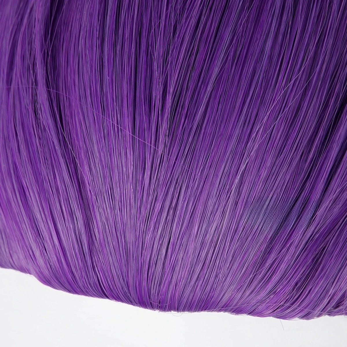 Close-up of long purple braided wigs showing vibrant purple hair texture.