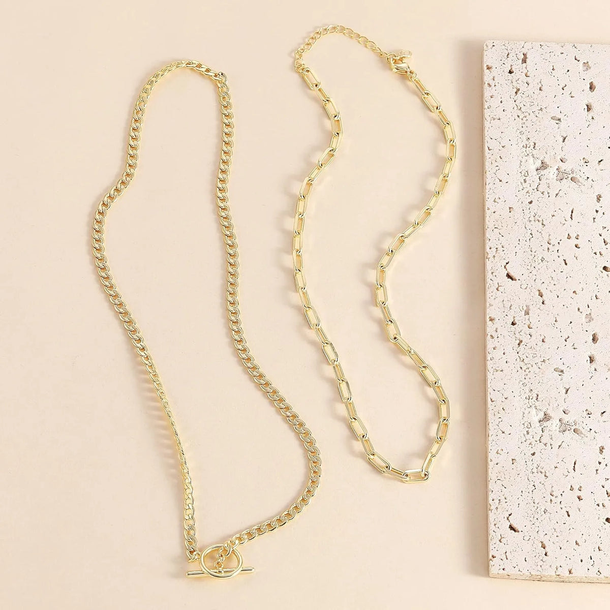 A delicate gold layered Cuban link necklace displayed against a light background.