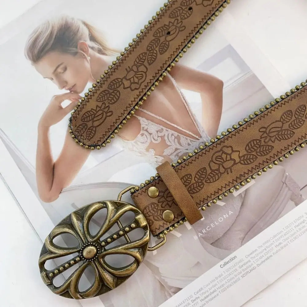 A vintage PU leather boho western belt with a decorative buckle is shown against a light background.