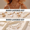 A set of layered boho necklaces featuring gold and pearl accents, including a shell, heart, starfish, and floral chain.