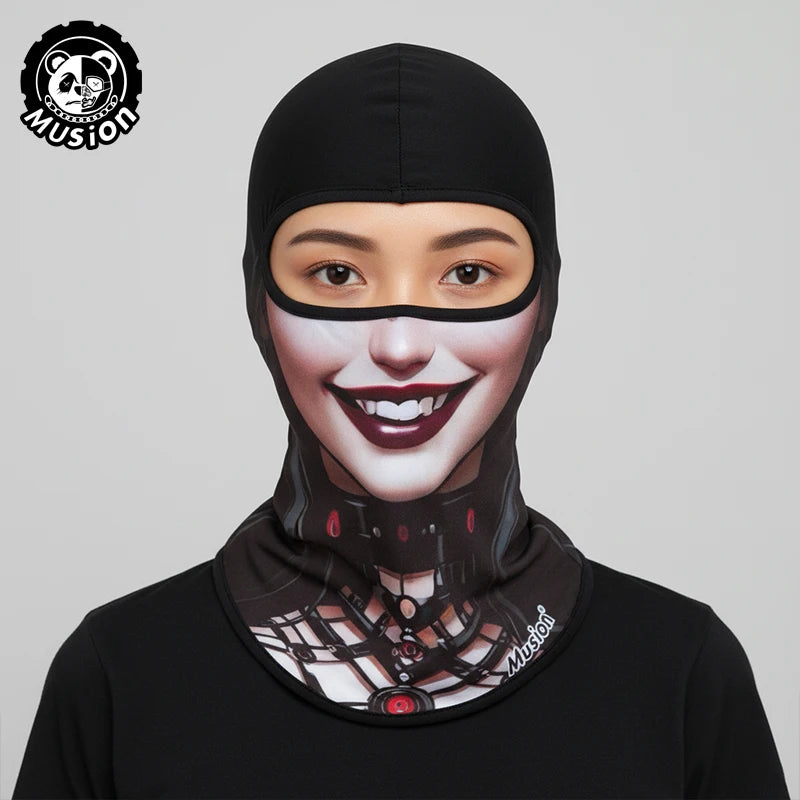 A woman wearing a black full face balaclava helmet liner with a stylized face design.