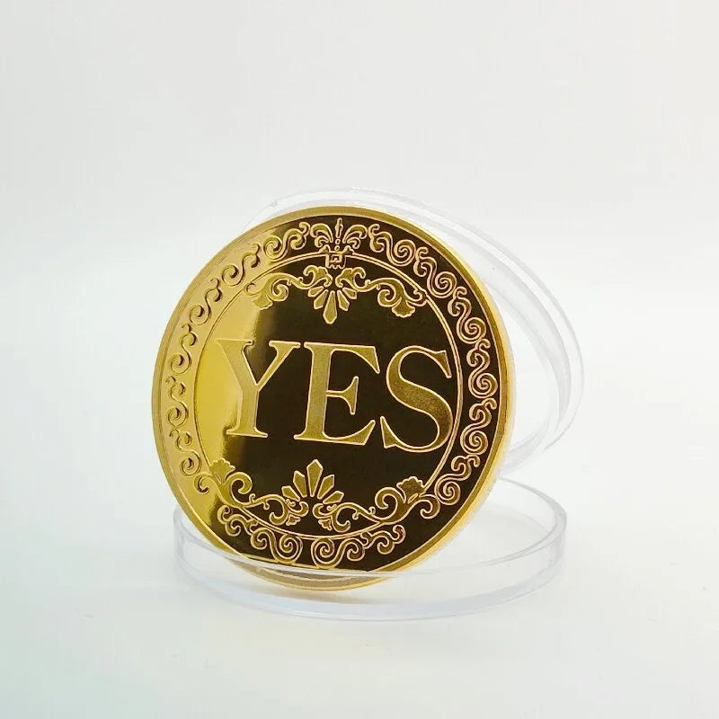 A vintage antique bronze decision coin with the word YES embossed on a circular design.