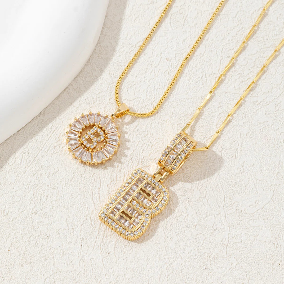 Gold necklace set featuring CZ crystal pendants shaped like the letters A and Z