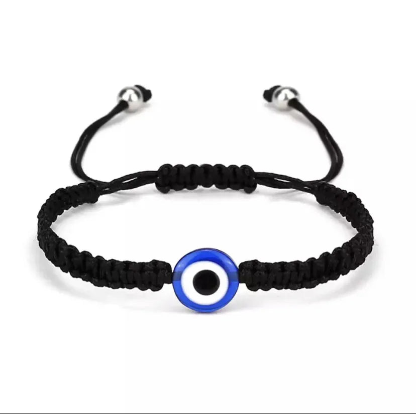 Black braided evil eye charm bracelet with a blue and white circular bead.