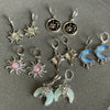 A collection of Y2K sun moon stainless steel hoop earrings featuring various designs and finishes.
