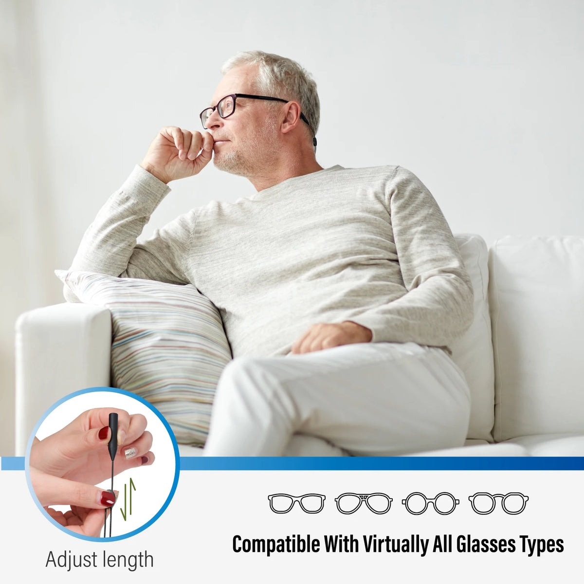 A man is adjusting the length of an anti-slip eyeglass retainer strap while sitting on a couch.