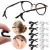 A set of black silicone ear hooks designed to secure eyeglasses, shown alongside a hand and various hook shapes.