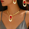 Gold and red oval three-ring buckle necklace set worn by a woman