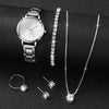 A silver quartz wristwatch, a diamond necklace, and three small diamond rings displayed on a black background.