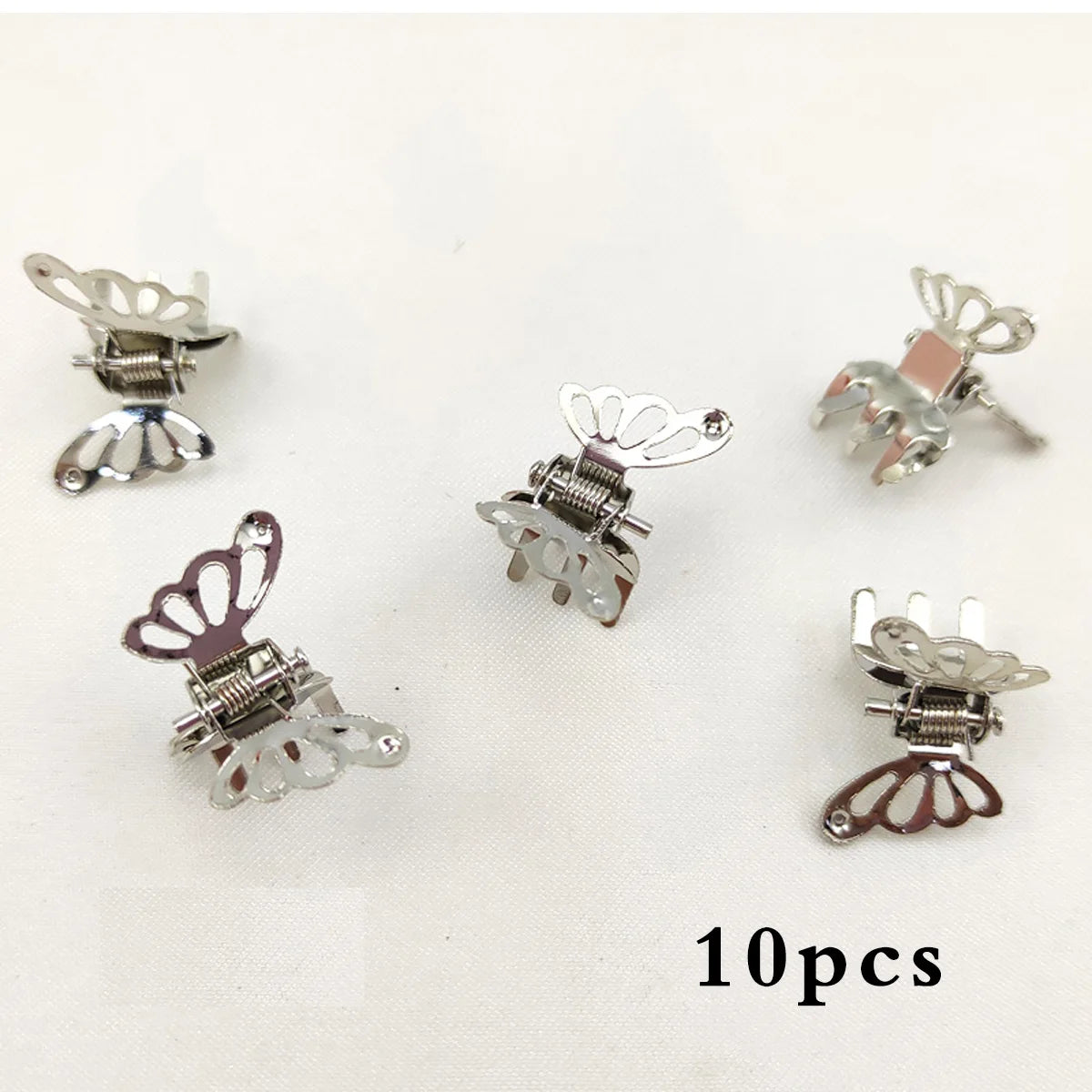 A set of ten mini hollow butterfly metal hair clips in silver and rose gold tones.