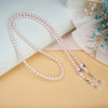 A delicate strand of pink pearls used as a chain lanyard is displayed on a light background.