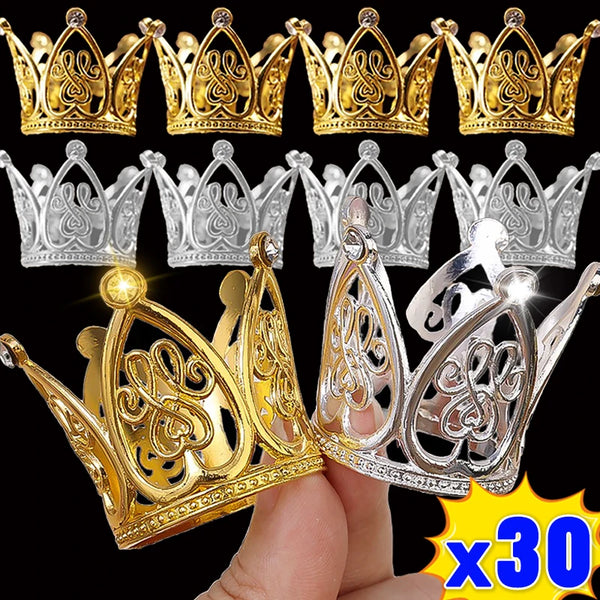 A collection of gold and silver mini crown cake toppers for parties shown on a hand.