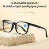 Un par de gafas presbiónicas negras anti-luz azul sobre una superficie blanca texturizada.