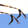 A pair of silicone anti-slip ear hooks with brown and orange marbled silicone tips.