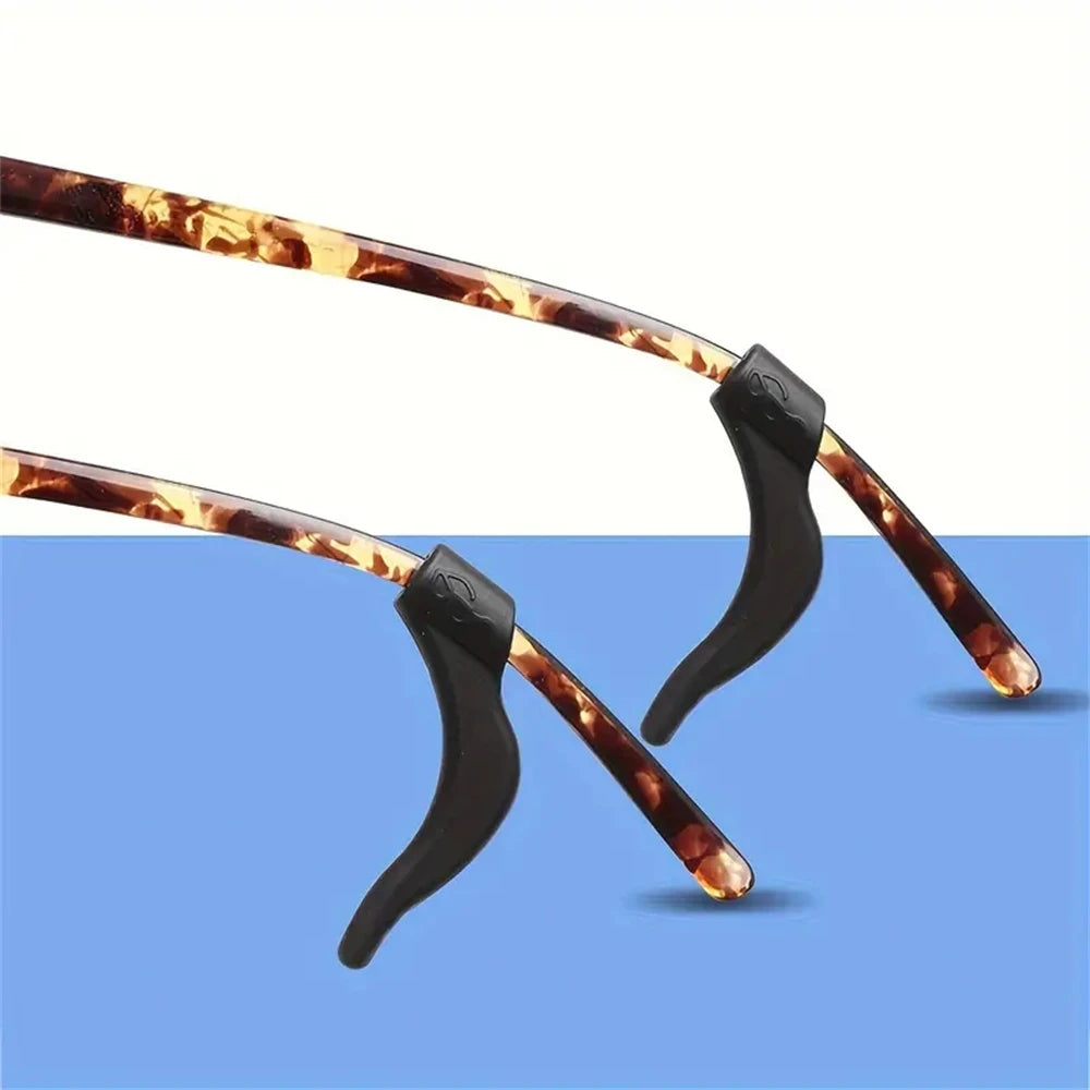A pair of silicone anti-slip ear hooks with brown and orange marbled silicone tips.