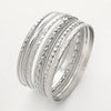 A stack of silver rings featuring various twisted and geometric patterns.