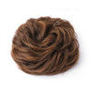 A close-up of a large messy bun hairstyle made from brown hair.
