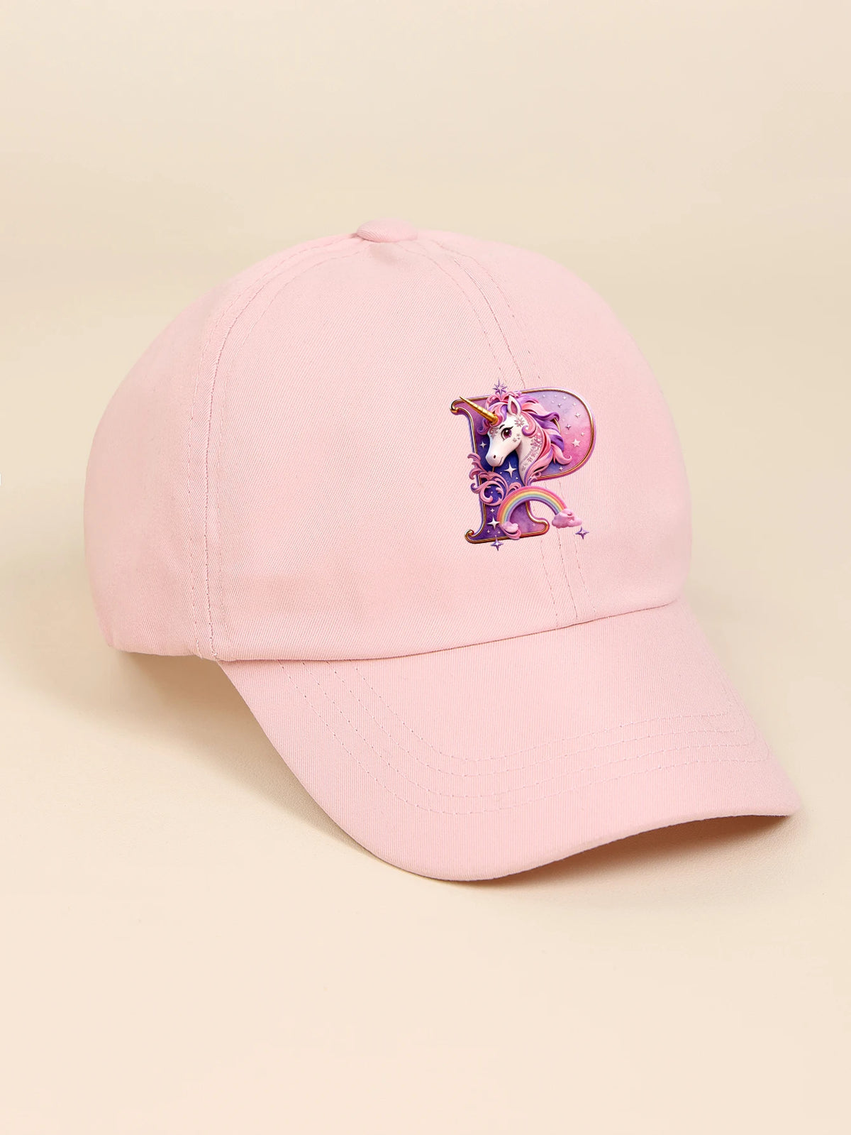 A pink baseball cap featuring a purple and white unicorn design.