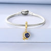 Sterling silver star moon charm bracelet with a round blue charm and a silver sphere clasp