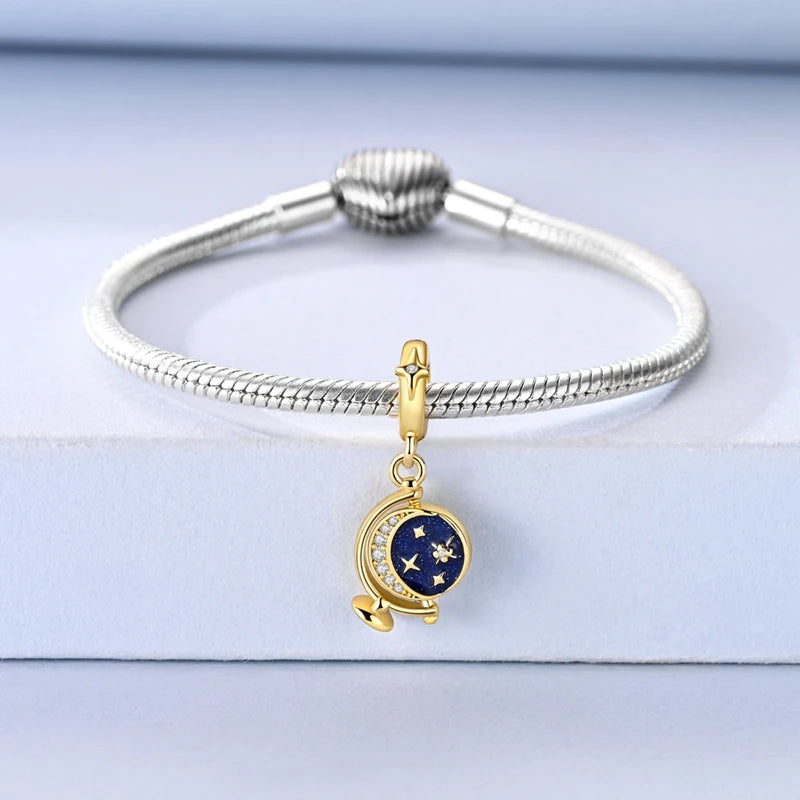 Sterling silver star moon charm bracelet with a round blue charm and a silver sphere clasp