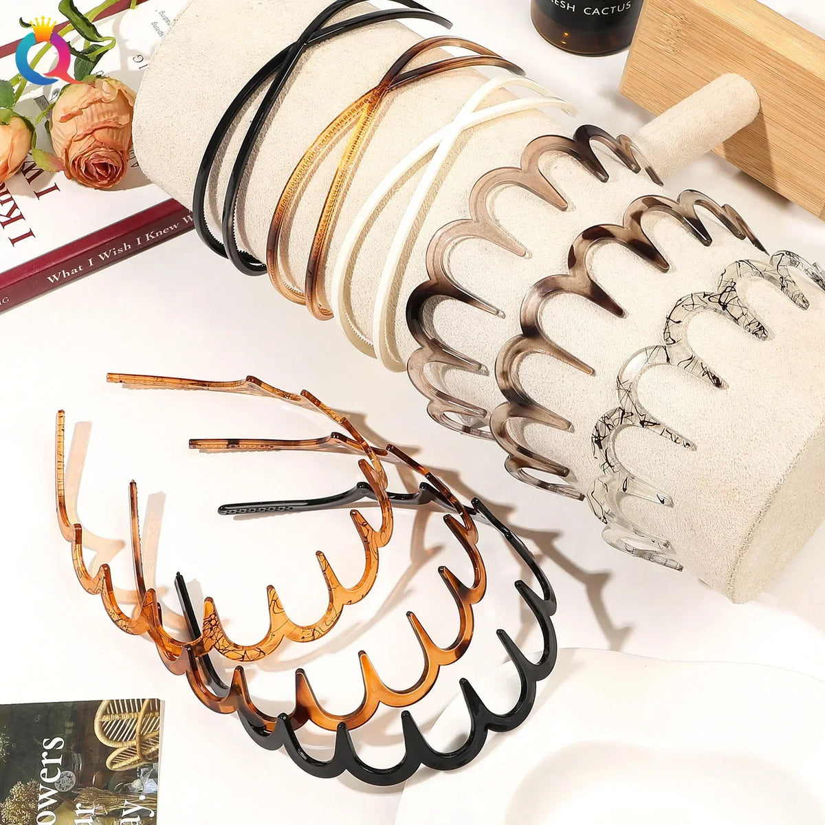 A collection of fashion acetate toothed headbands in various natural and dark tones displayed on a white background.